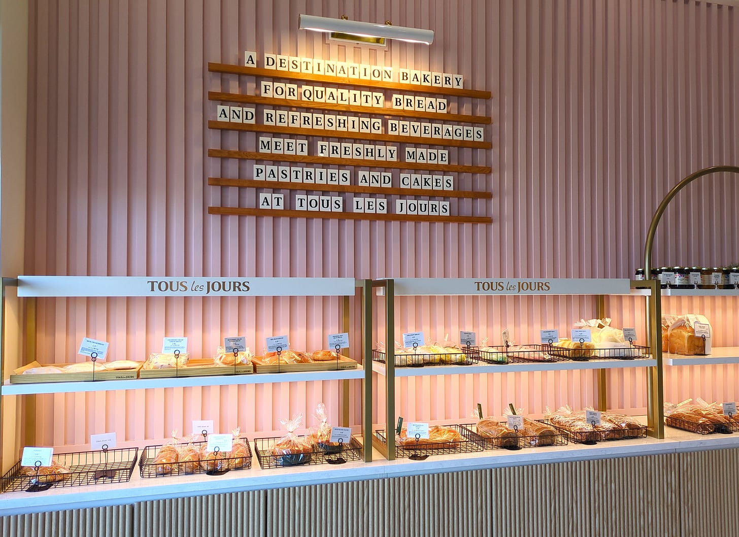 A display case full of baked goods along the wall by the entrance A display case full of baked goods along the wall by the entrance