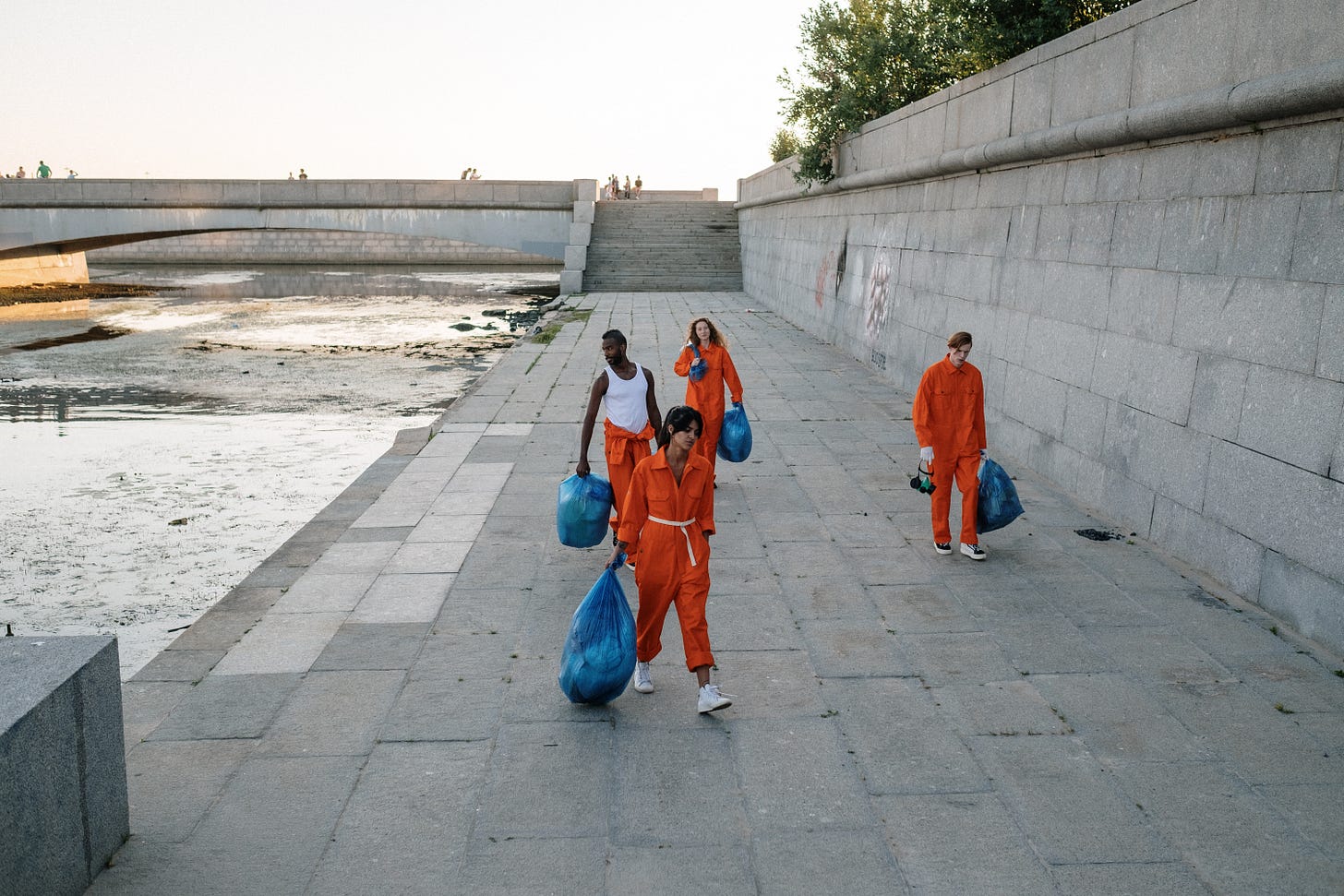 Photo by cottonbro: https://www.pexels.com/photo/group-of-people-carrying-trash-in-plastic-bags-9246483/