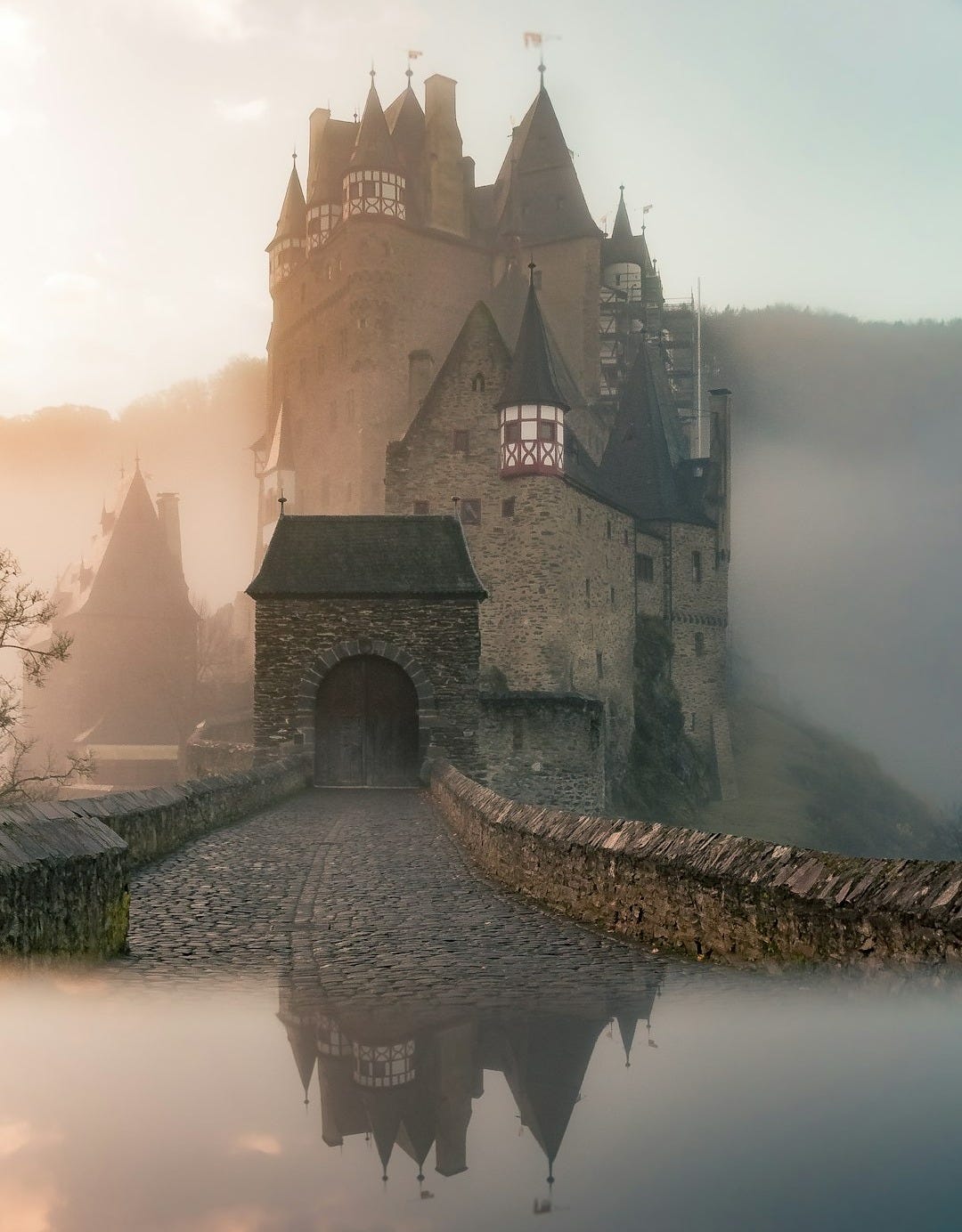 reflection of a castle surrounded with fogs
