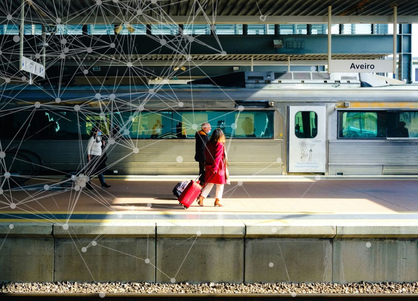 Travelers wait at a sunlit train platform in Aveiro, Portugal Travelers wait at a sunlit train platform in Aveiro, Portugal