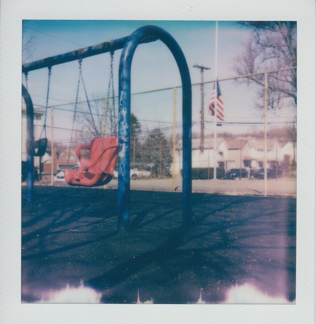 Polaroid of accessible swing at East Carnegie Park.