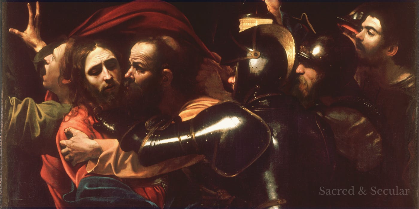 Caravaggio’s The Taking of Christ, showing Judas embracing and kissing Jesus as armed soldiers close in around them. Jesus appears calm and sorrowful, while the surrounding figures are crowded together in dramatic darkness, illuminated by a strong light across their faces and armour. Caravaggio’s The Taking of Christ, showing Judas embracing and kissing Jesus as armed soldiers close in around them. Jesus appears calm and sorrowful, while the surrounding figures are crowded together in dramatic darkness, illuminated by a strong light across their faces and armour.