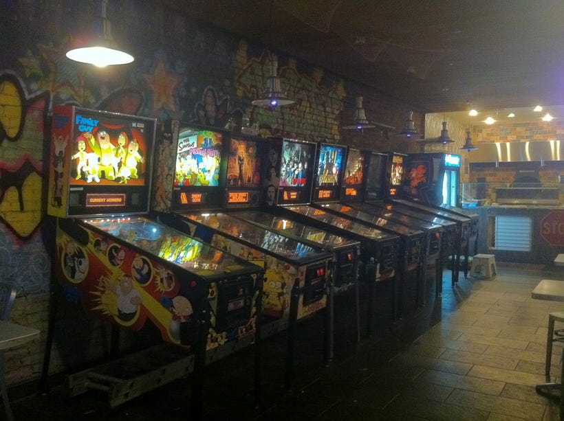 A random assortment of pinball tables taken on an old smartphone camera