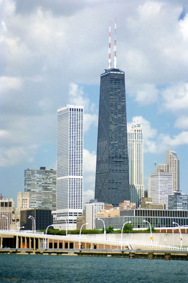 Water Tower Place (white) and the John Hancock Center (dark) dominating the Chicago skyline, as seen from Navy Pier, July 1996. Water Tower Place (white) and the John Hancock Center (dark) dominating the Chicago skyline, as seen from Navy Pier, July 1996.