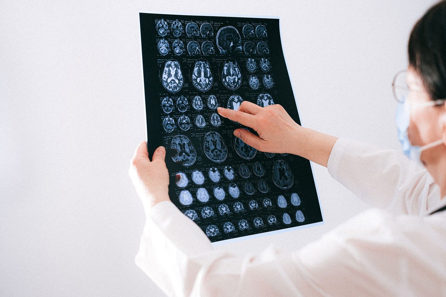 A radiologist reviewing AI-generated report text alongside the chest X-ray image