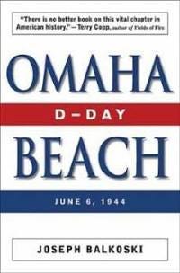 A white cover with the title “Omaha” centered in blue text, and below centered also in blue text is “Beach”. A center red band between Omaha and Beach contains “D-Day” in white text. Below Beach is a blue band with “June 6, 1944” in white text. The author, “Joseph Balkoski” appears in black lettering at the bottom of the cover surrounded by a black lined box. 