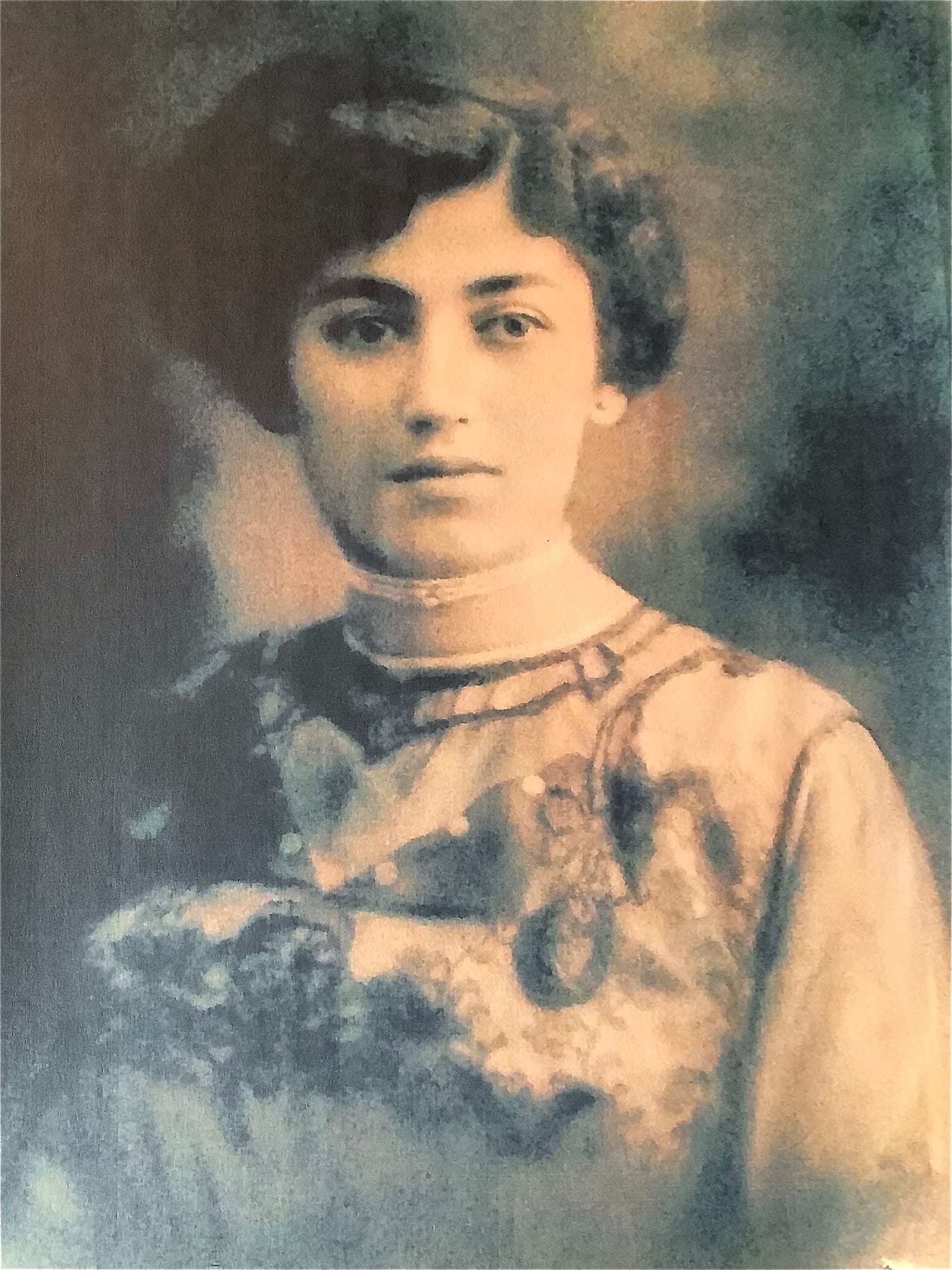 A black and white studio portrait of a young Italian woman. Her hair is in an upswept do and she's wearing a light colored dress with a high collar and an embroidered bodice