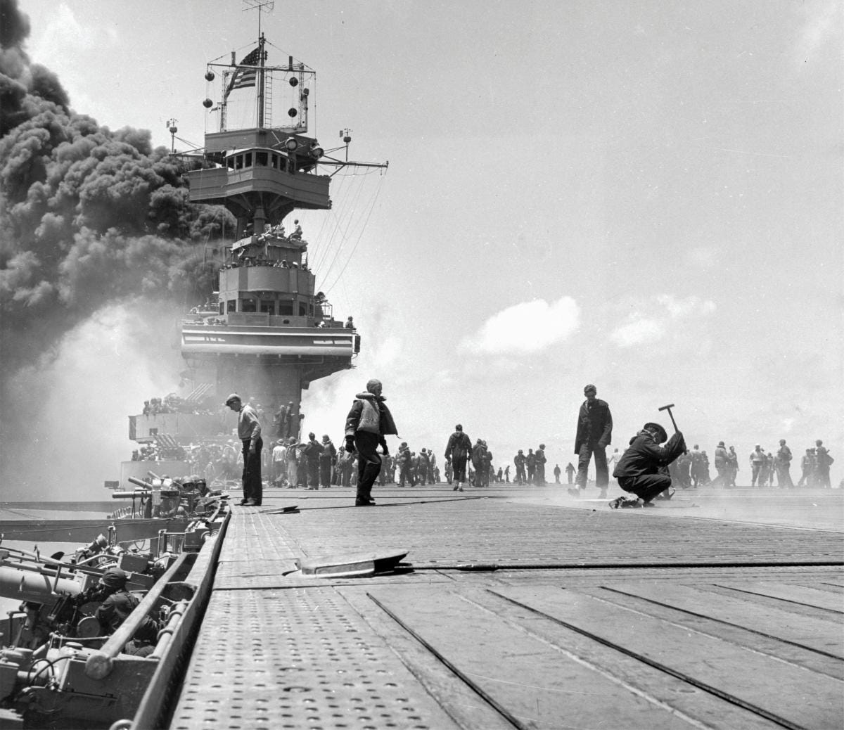 Crewmen repair bomb damage to the flight deck of the USS Yorktown (CV-5) on 4 June 1942 during the Battle of Midway Crewmen repair bomb damage to the flight deck of the USS Yorktown (CV-5) on 4 June 1942 during the Battle of Midway