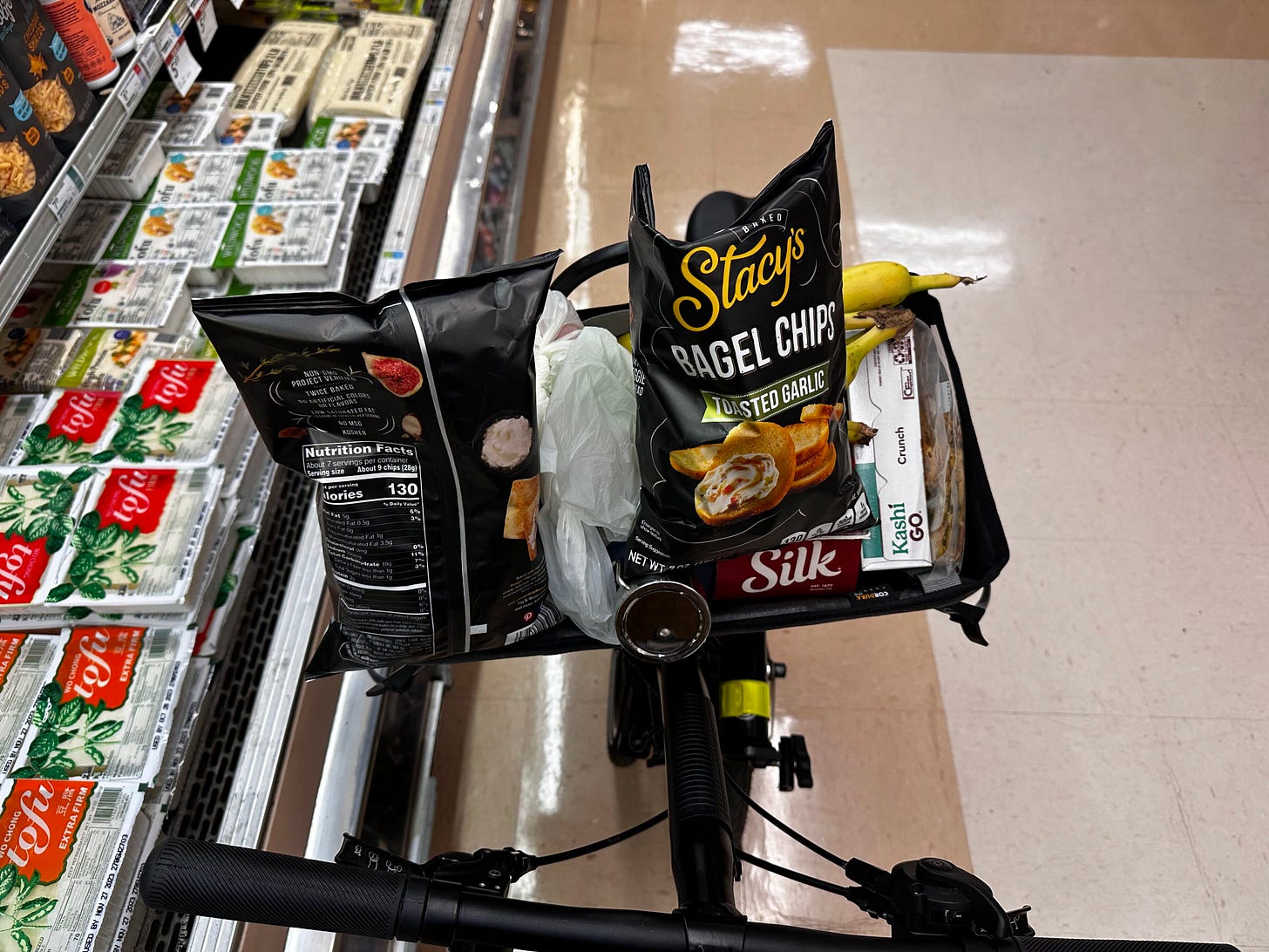 Basket filled with Bagel Chips. The author humorously calls these "necessities".