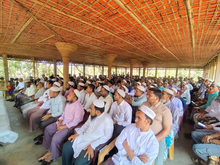 packed hall attends a United Council of Rohingya (UCR) meeting in the camps. 