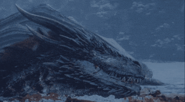 GIF of a dragon sliding into icy water from Game of Thrones. 