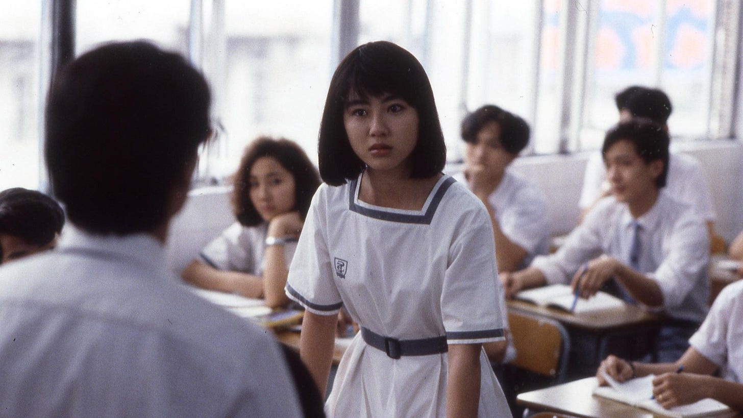 School on Fire | Still features Fennie Yuen as Chu Yuen Fong in a classroom, standing up.