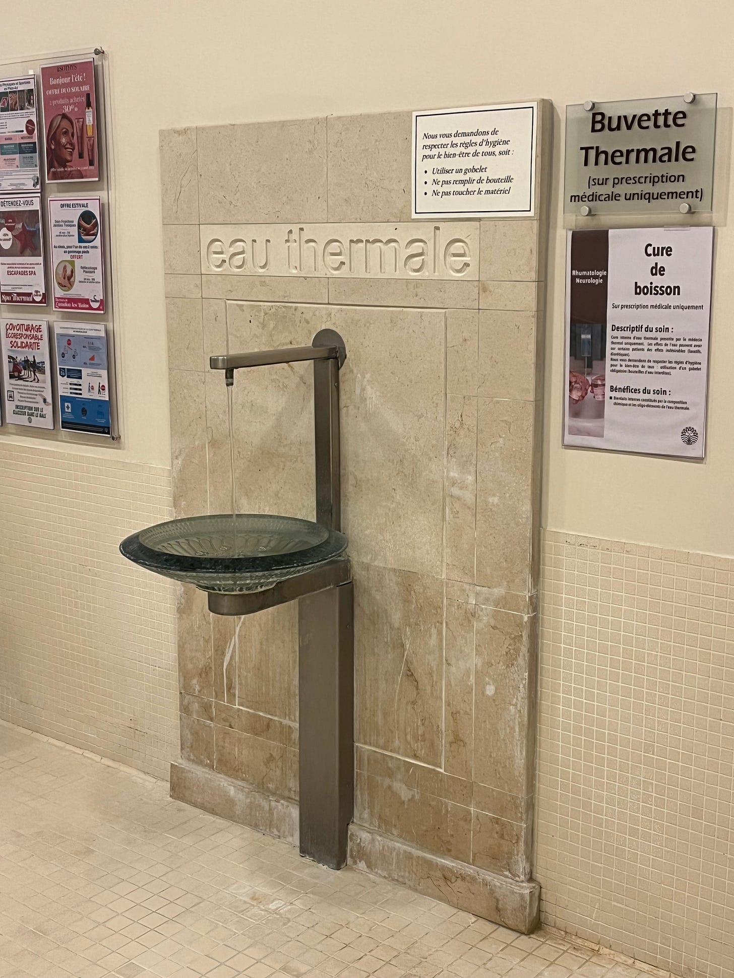 Photo of a fancy water fountain which says "eau thermale"
