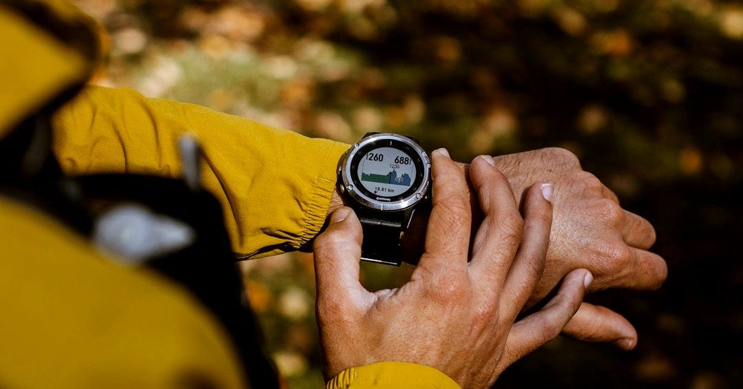 a man in a yellow jacket holding a compass