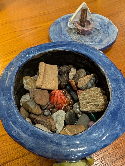 Three images of a blue ceramic container, hand-sculpted by Ahava.