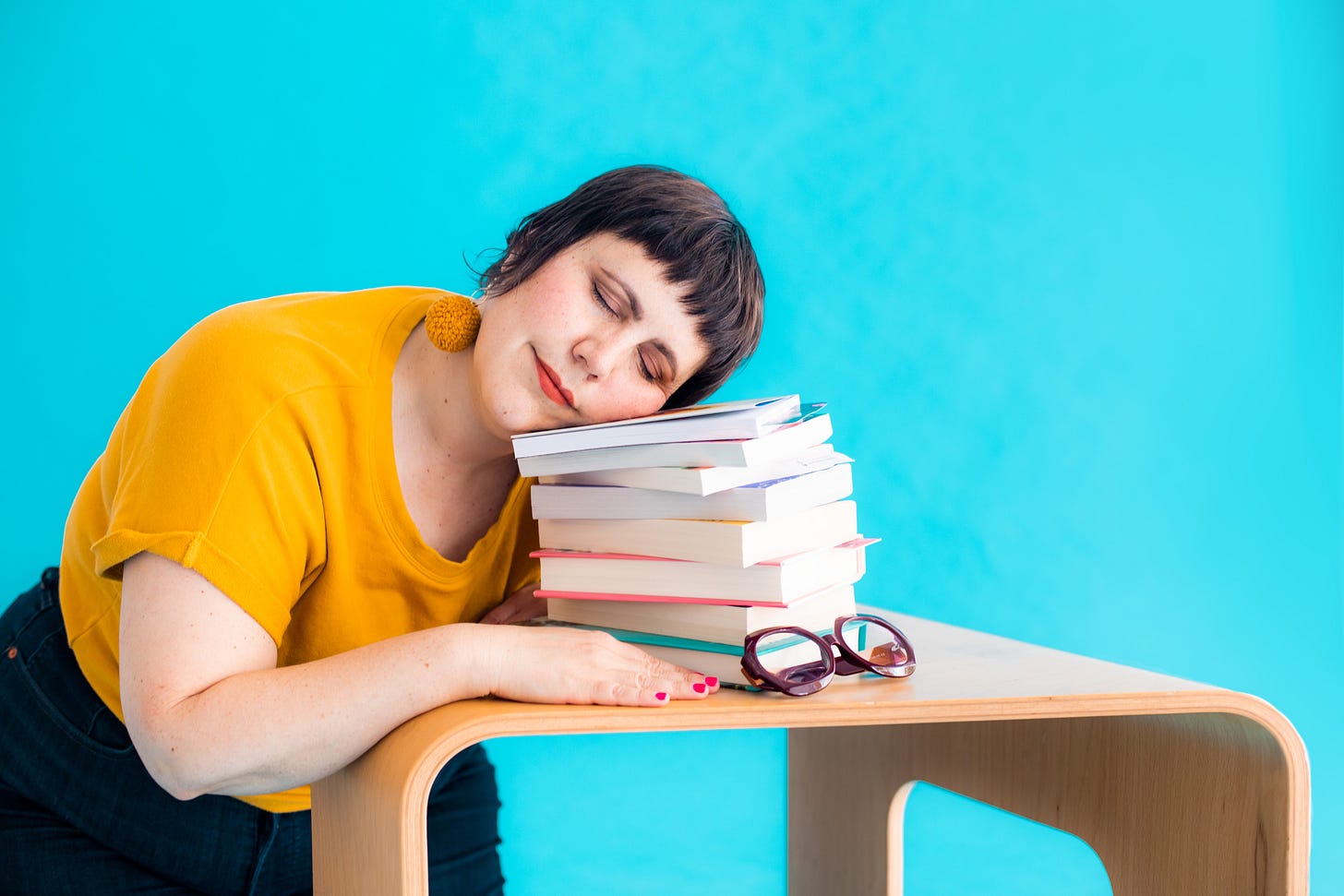 Lauren napping on a pile of books