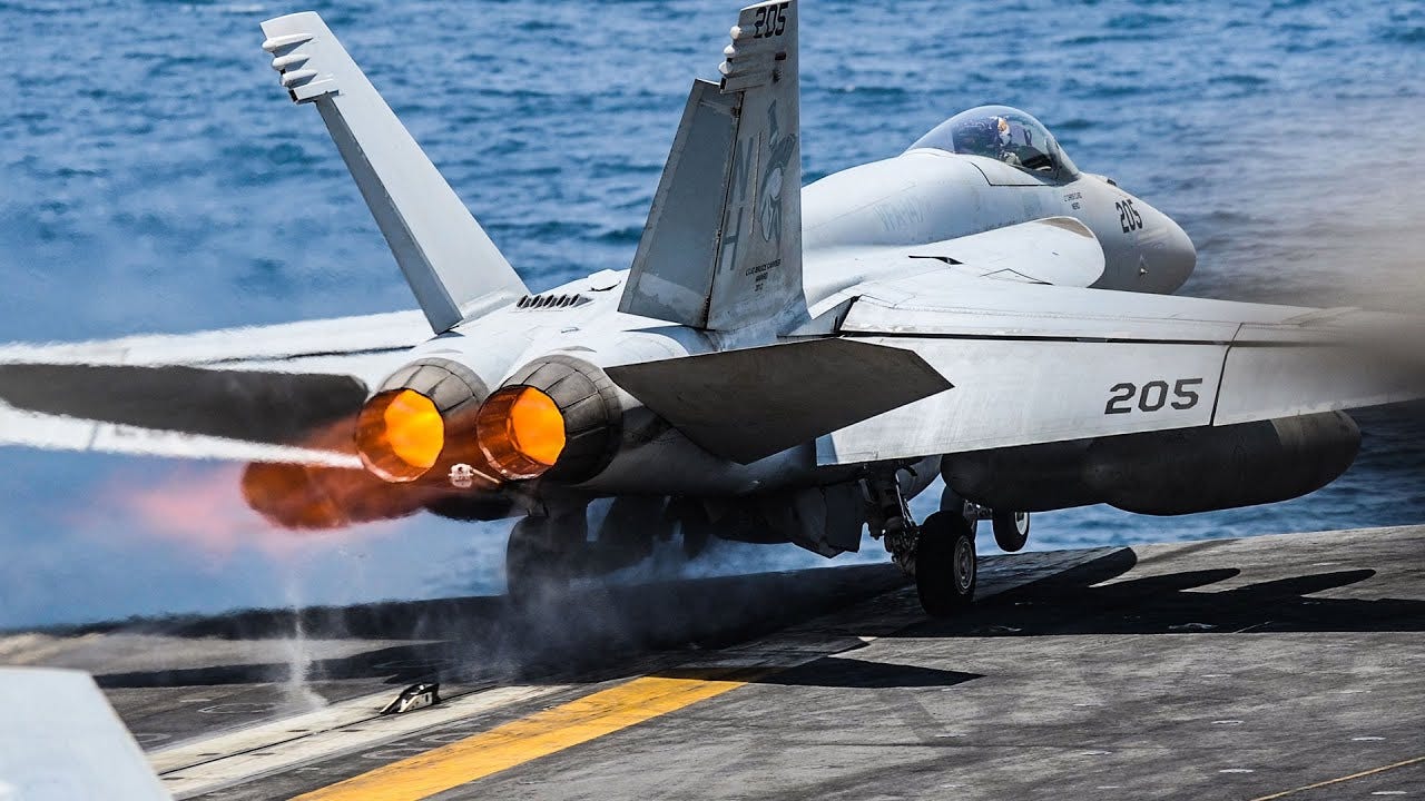 F/A-18 Super Hornets manoeuvring, taking off and landing on the flight deck  of aircraft carrier