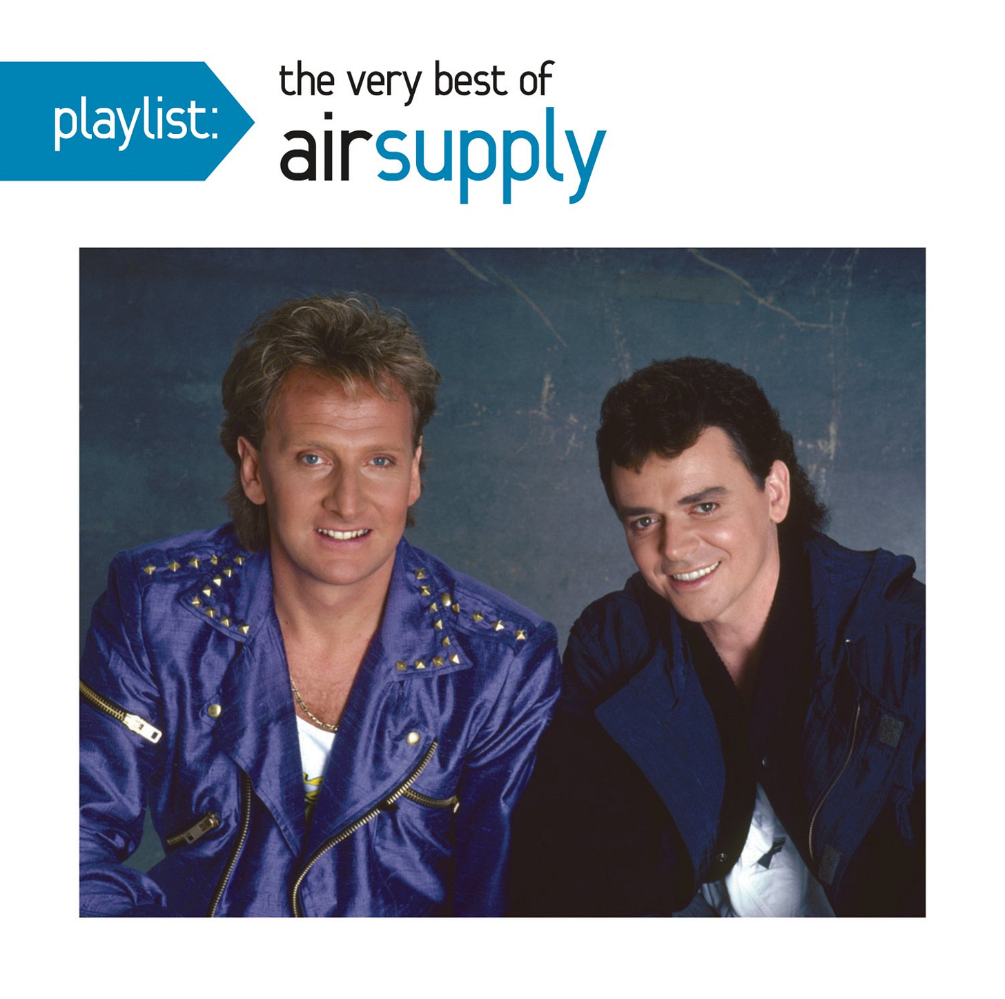 playlist of very best of air supply; one blond guy with a blue studded jacket; one brown haire dguy with a dark shirt, sitting together staring at camera