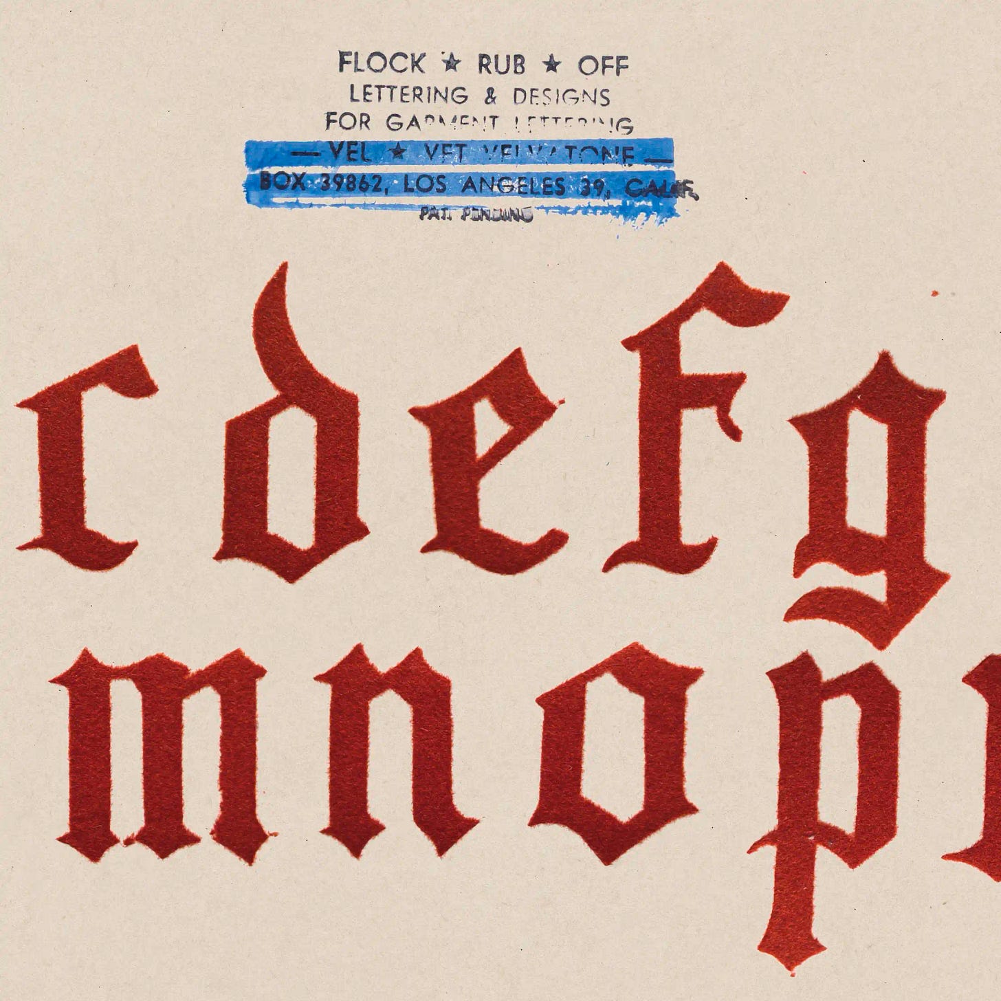 Cropped view of red velvet-flocked Gothic alphabet on cream cardstock, stamped 'Velvet Velvatone, Box 39862, Los Angeles 39, California