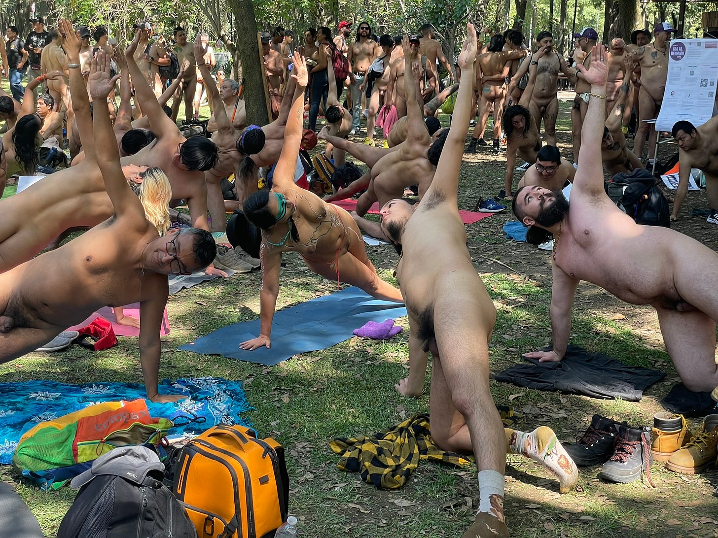 Nude participants practice yoga together beneath the trees during a group wellness session at Día al Desnudo 2026 in Mexico City. Nude participants practice yoga together beneath the trees during a group wellness session at Día al Desnudo 2026 in Mexico City.