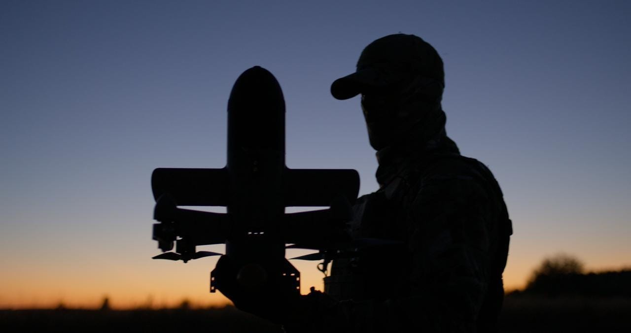 A silhouette of a person holding a missile

AI-generated content may be incorrect.