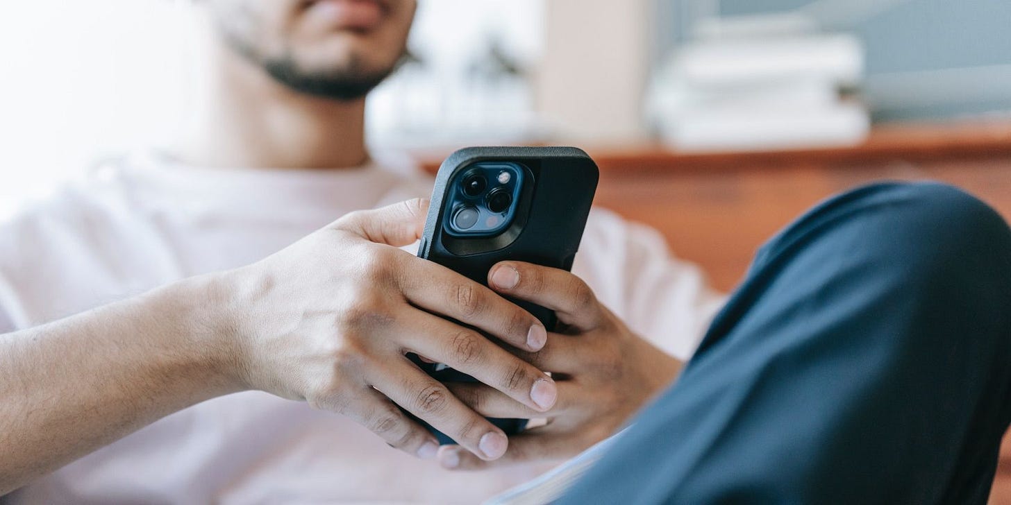 A man holding an iPhone A man holding an iPhone