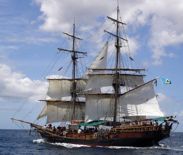 A large wooden ship with white sails

AI-generated content may be incorrect.