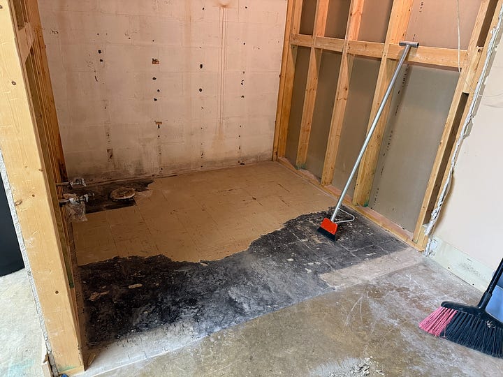 Four images showing a bathroom being demolished.