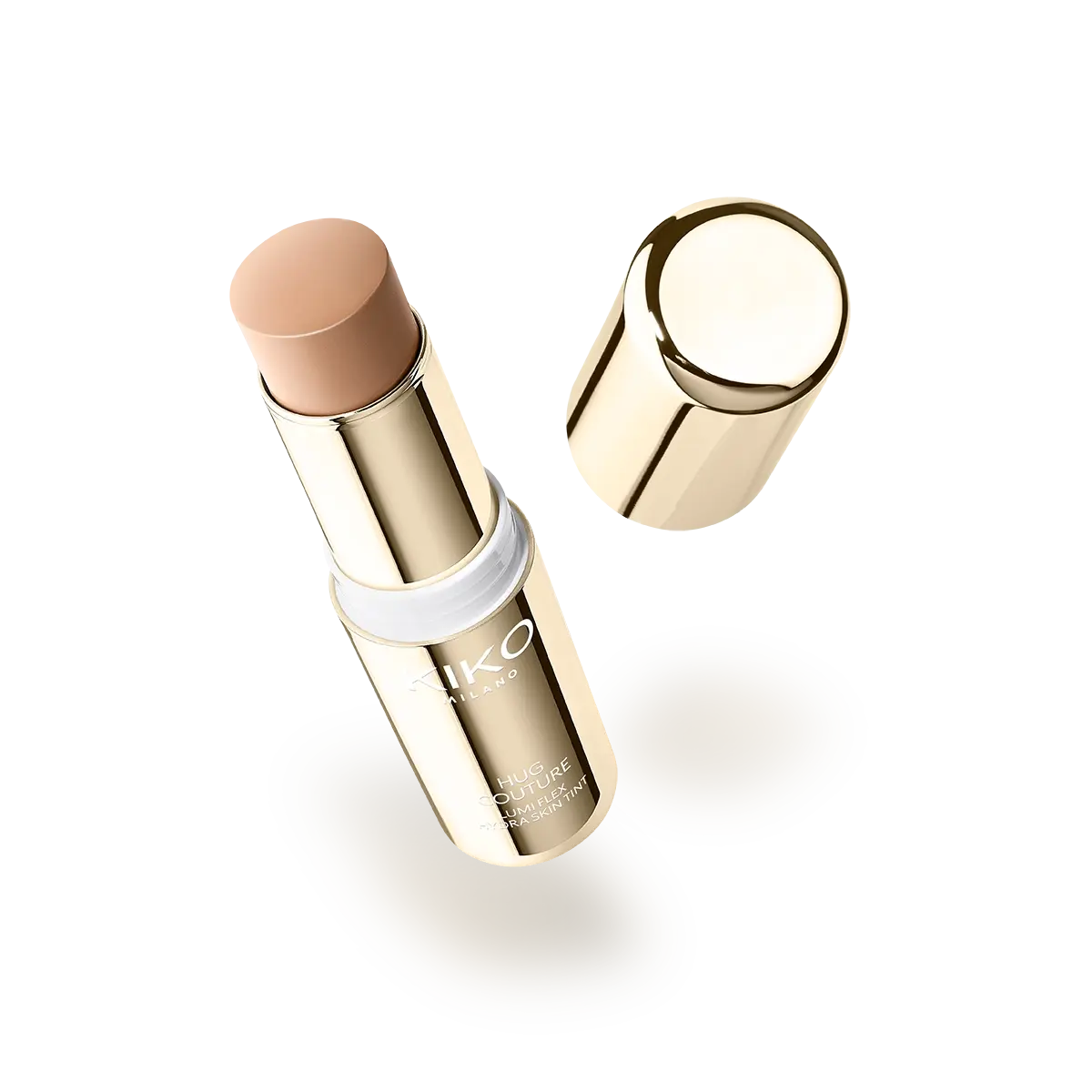 A close-up of the Kiko Milano 'Lumi Flex Hydra Skin Tint Stick', showing the foundation product twisted up from its chunky, light-gold metallic base. The foundation has a cream-to-liquid golden shade and a domed, easy-swipe top, emphasizing mess-free application. A close-up of the Kiko Milano 'Lumi Flex Hydra Skin Tint Stick', showing the foundation product twisted up from its chunky, light-gold metallic base. The foundation has a cream-to-liquid golden shade and a domed, easy-swipe top, emphasizing mess-free application.