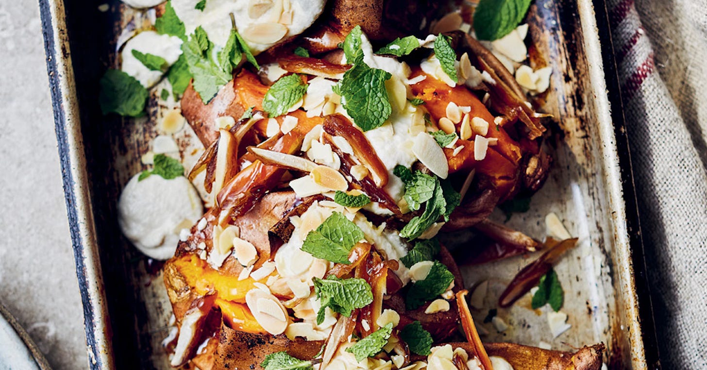 A delicious dish of sweet potatoes with almond sauce, dates and chopped mint A delicious dish of sweet potatoes with almond sauce, dates and chopped mint