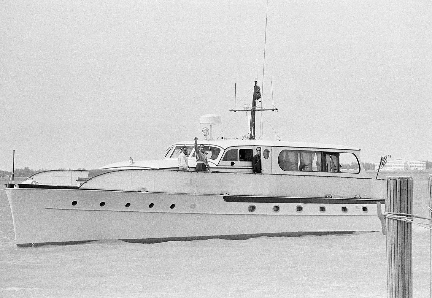 President Richard Nixon waves from the government yacht 'Julie' with friend Charles G. 'Bebe' Rebozo, departing Key Biscayne Yacht Club for a Biscayne Bay cruise, March 9, 1969. President Richard Nixon waves from the government yacht 'Julie' with friend Charles G. 'Bebe' Rebozo, departing Key Biscayne Yacht Club for a Biscayne Bay cruise, March 9, 1969.