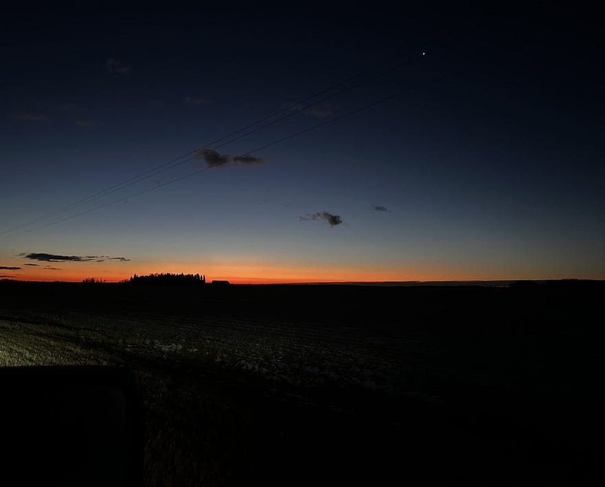 The moment before sunrise, the sun is about to come over the horizon, all is black except for a rainbow of color that presages the dawn, Tim’s Grateful 8, Ubiquity