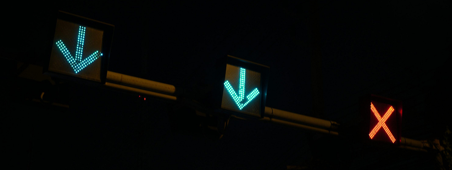 a couple of traffic lights that are on a pole