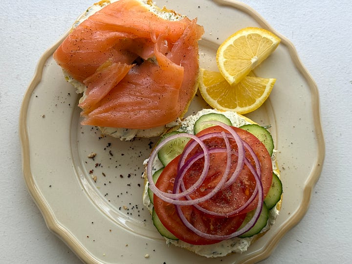egg bagels on a sheet tray and a photo of a bagel with lox tomato and onion
