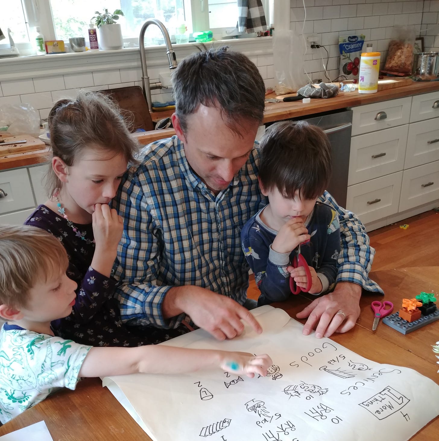Kids learning with dad around the dinner table