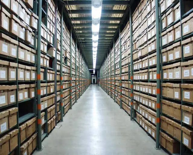 Photo of racks of file boxes at an archive center Photo of racks of file boxes at an archive center
