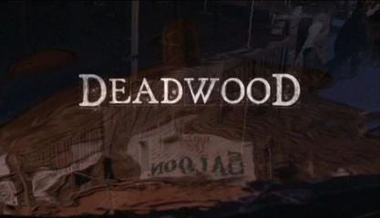 This image shows the title card of David Milch's HBO series Deadwood (2004-2006). The word "Deadwood" lies in the center of a shot of the town's main saloon and thoroughfare as reflected in a rain puddle. This image shows the title card of David Milch's HBO series Deadwood (2004-2006). The word "Deadwood" lies in the center of a shot of the town's main saloon and thoroughfare as reflected in a rain puddle.
