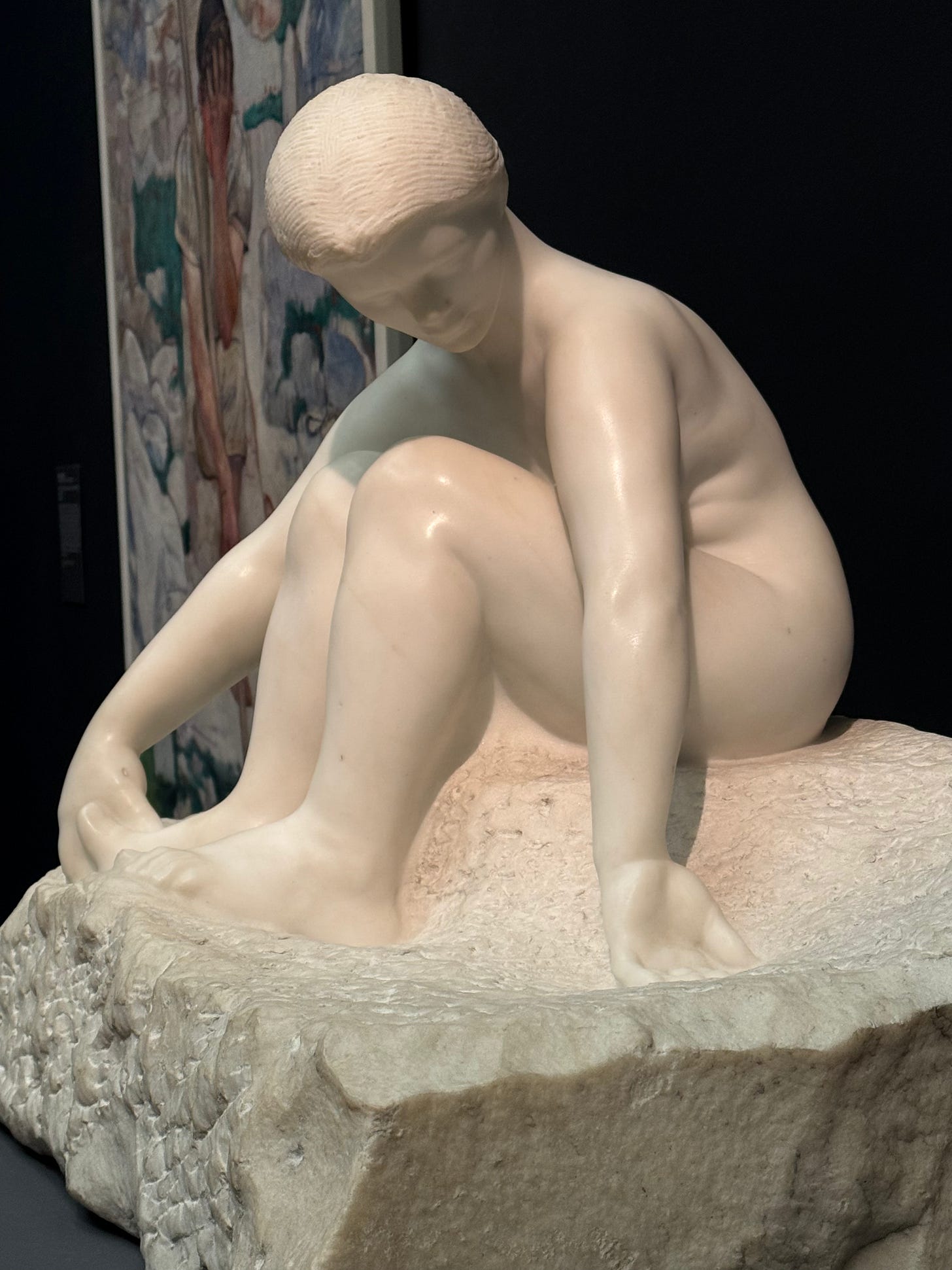 sculpture in white marble, seated girl bending and touching her feet