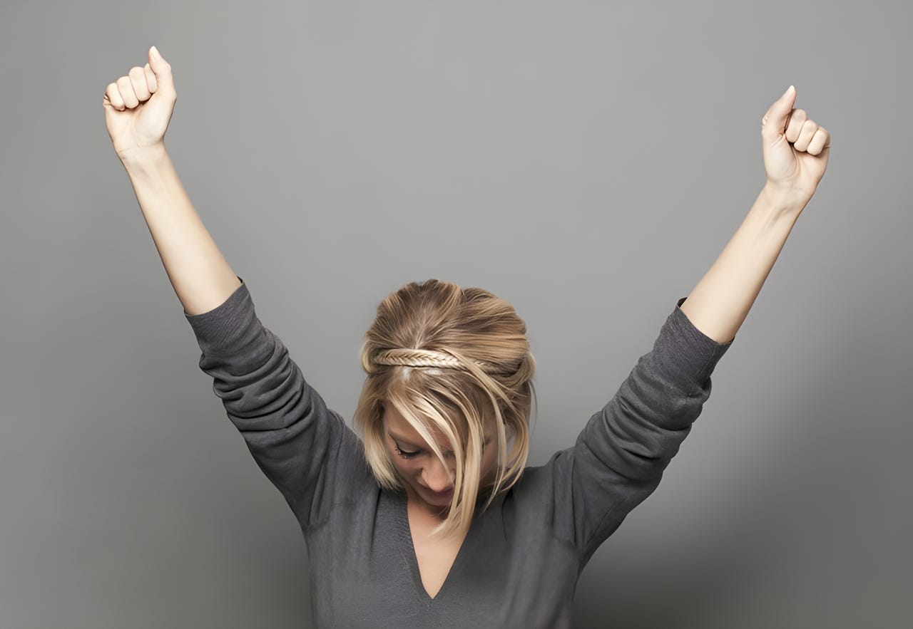 Woman raising her arms in a V for victory