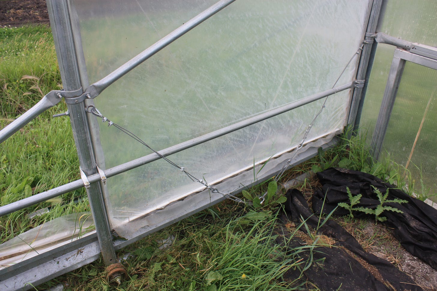turnbuckles attaching the high tunnel to the track