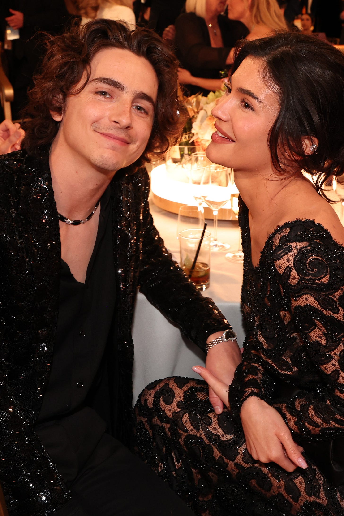 Image may contain Timothe Chalamet Jonny Lee Miller Clothing Formal Wear Suit Cup Accessories Jewelry and Necklace