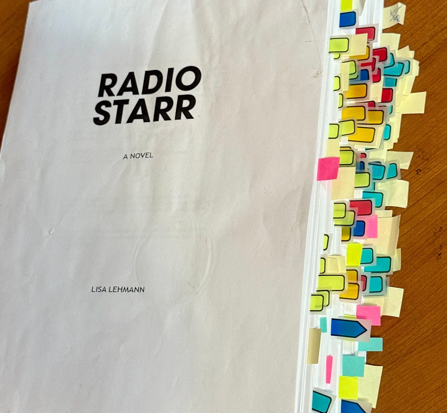 a printed manuscript full of tabs marking pages needing to be edited a printed manuscript full of tabs marking pages needing to be edited