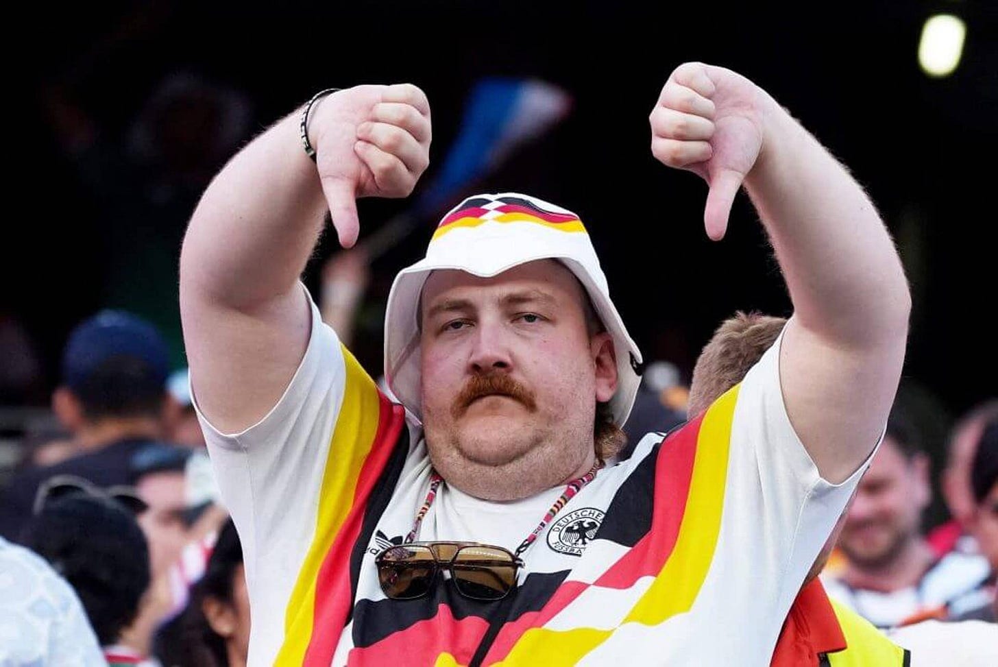 A German football fan reacts after the game by pointing two thumbs downwards A German football fan reacts after the game by pointing two thumbs downwards