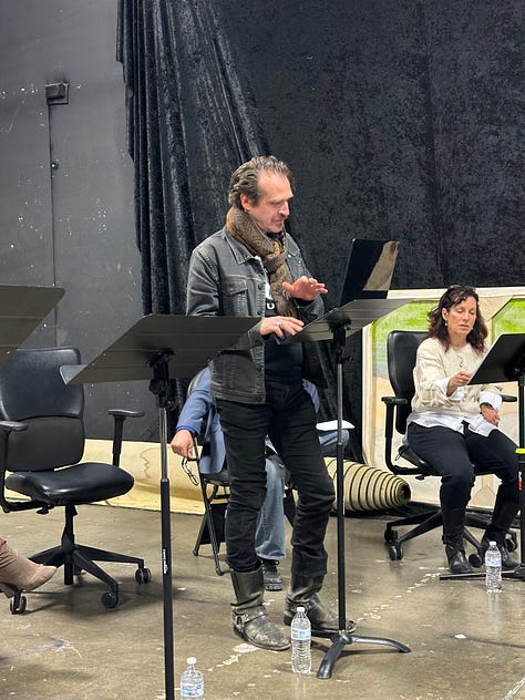 Actors reading a play in a theater.