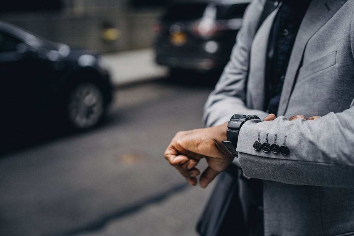 Free Crop unrecognizable punctual black businessman in formal outfit checking time on sidewalk in modern city Stock Photo Free Crop unrecognizable punctual black businessman in formal outfit checking time on sidewalk in modern city Stock Photo