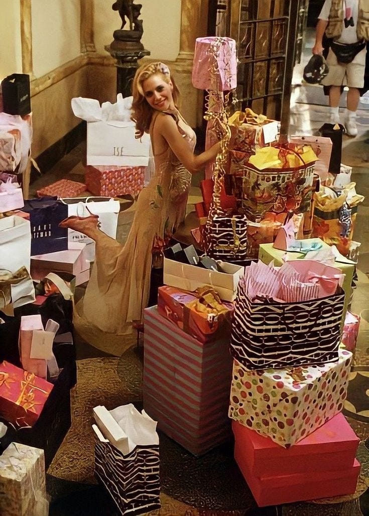 This may contain: a woman standing next to lots of presents