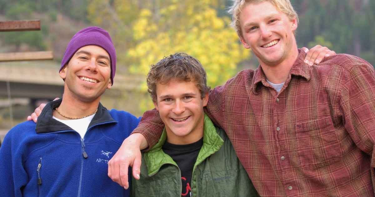 Three Friends Posing Outdoors with Smiles