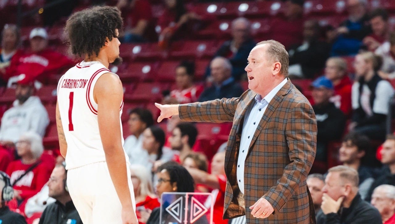 Wisconsin basketball head coach Greg Gard gestures while speaking with guard Braeden Carrington (1) on the sideline at the Kohl Center.