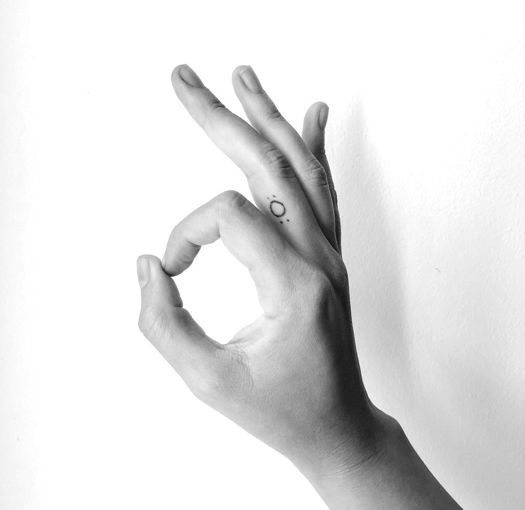 persons left hand on white surface