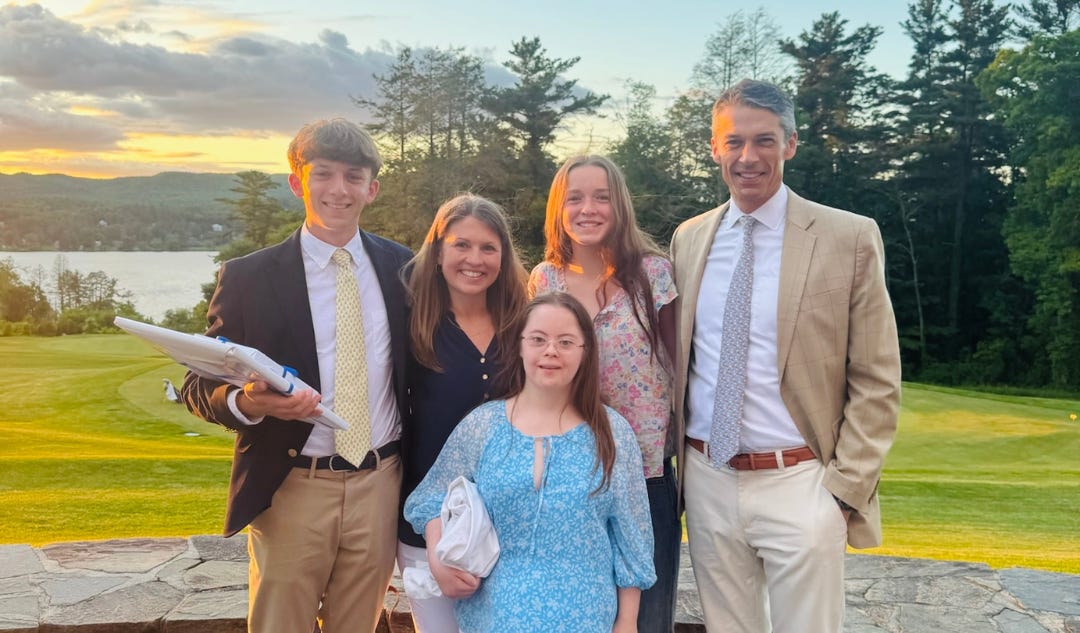 Our family dressed up for graduation, with a setting sun behind us